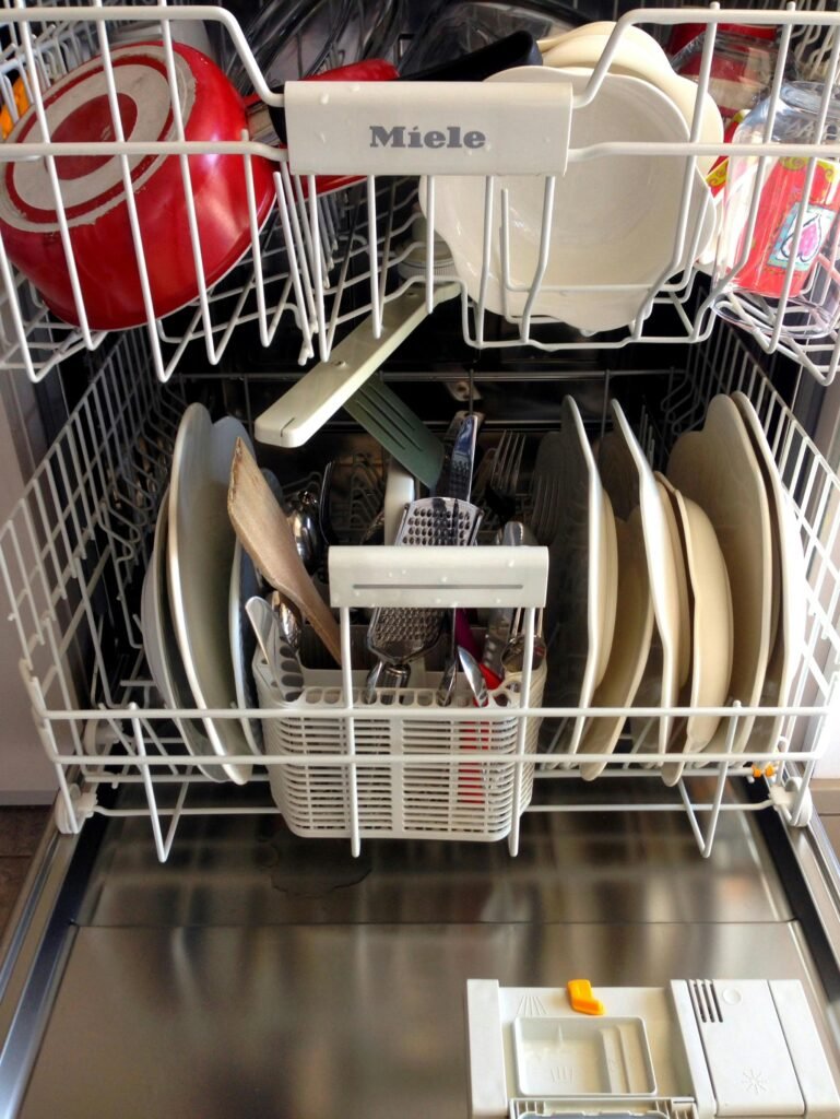 "Dishwasher loaded with dirty dishes and utensils ready for professional dishwasher repair in Colorado Springs, CO."