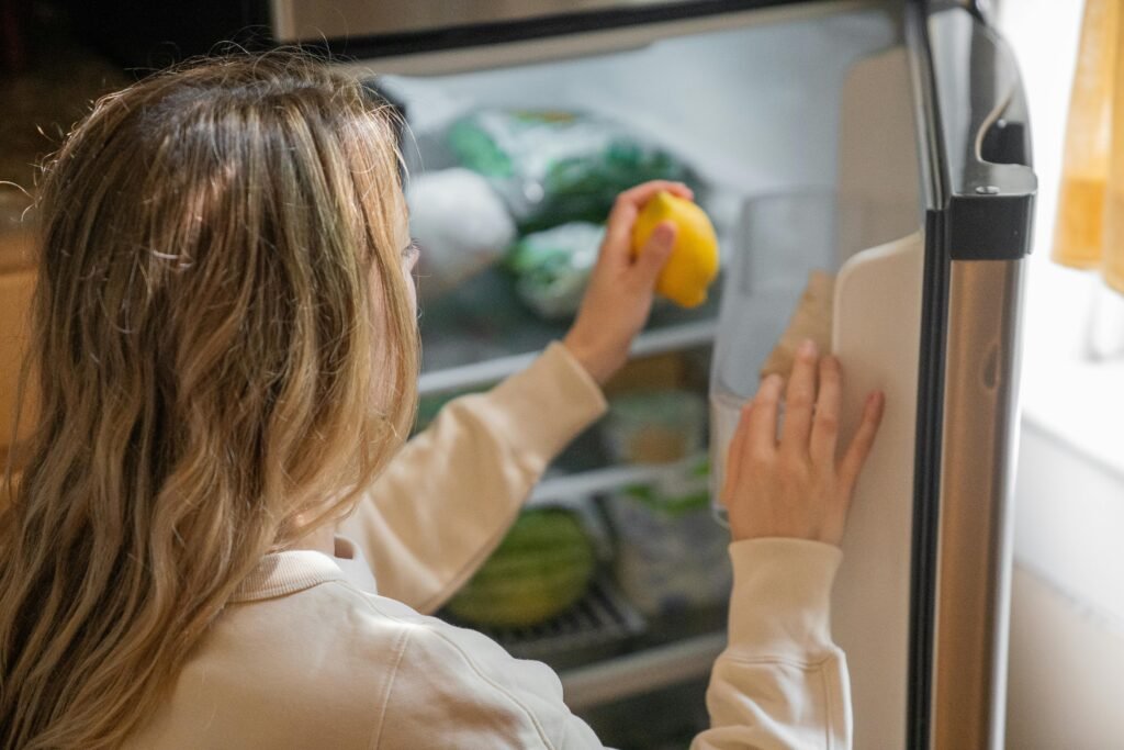 Person checking food in a freezer needing repair in Colorado Springs