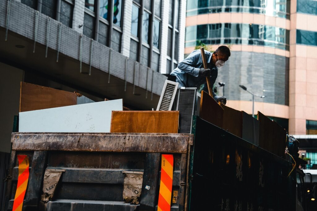 Worker removing bulky waste for garbage disposal services in Colorado Springs